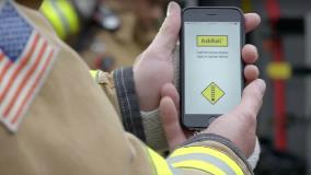 Firefighter views the AskRail app on mobile phone