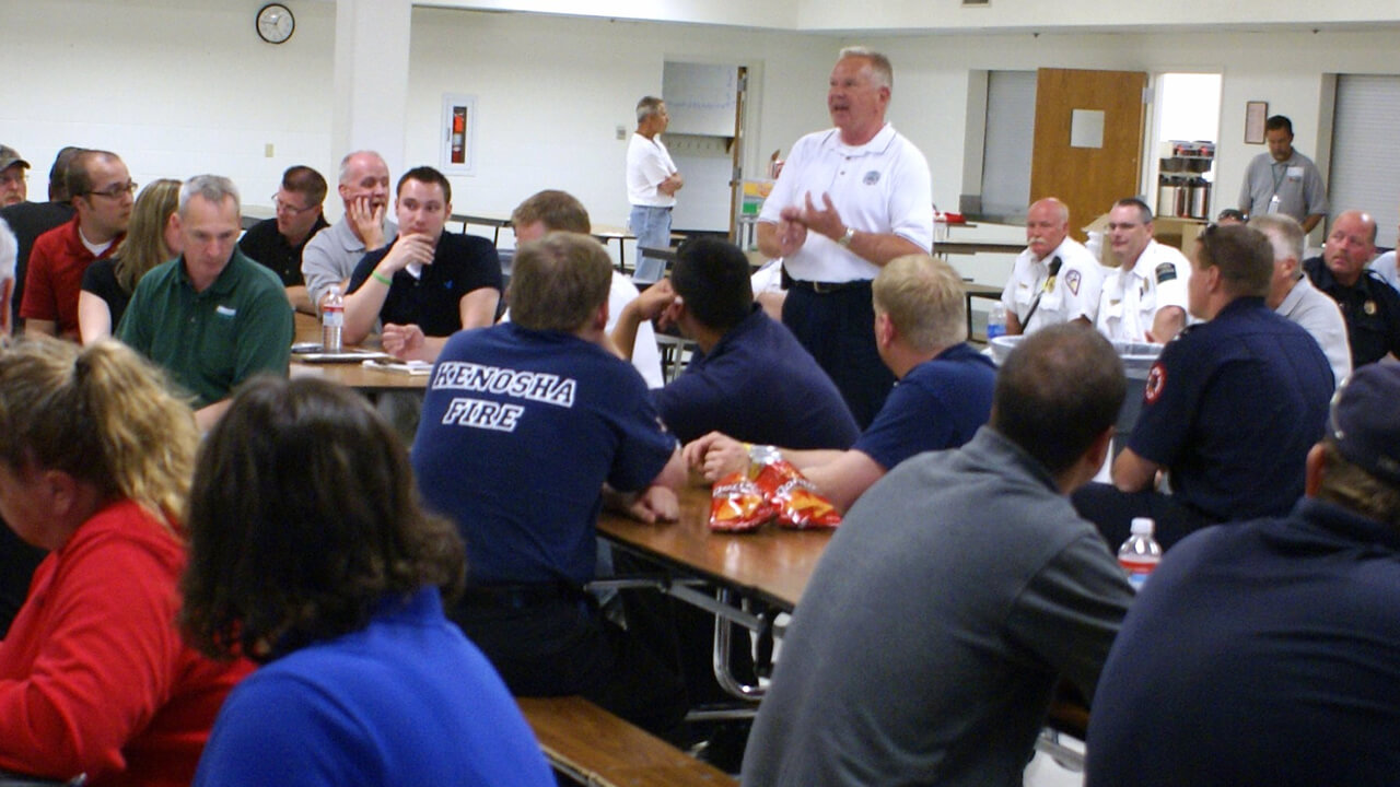 Chief talking to a group of volunteer personnel and recruits