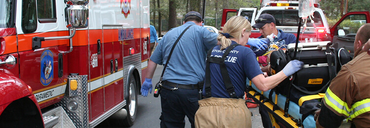 EMTs taking a patient to an ambulance